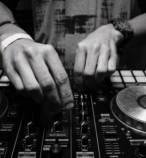 grayscale-photography-of-person-using-dj-controller-860707